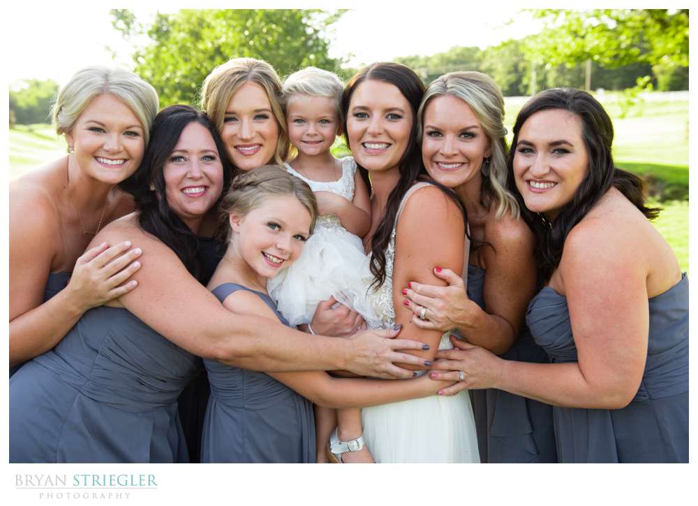 bridesmaids hugging bride
